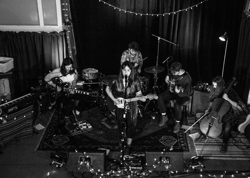 Music students playing instruments in a band with fairy lights