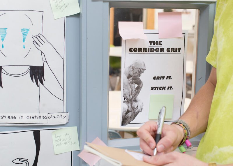 Creative advertising student in a lime t-shirt working near mood board