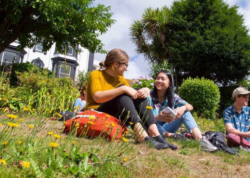 Students chatting in Woodlane Campus gardens.