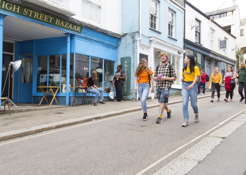 Three students walking down Falmouth high street