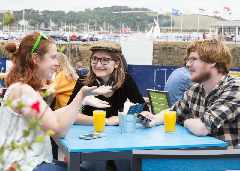 Students drinking orange juice at table