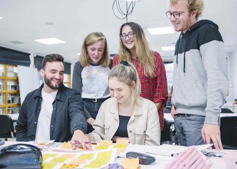 Graphic Design group of students around table