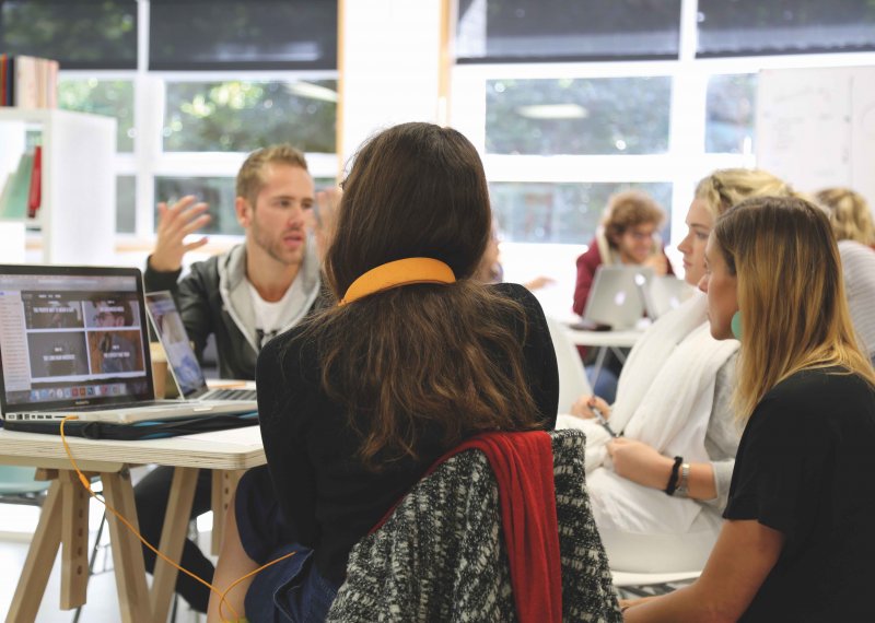 MA Graphic Design students chatting around a table