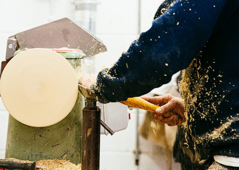 Close up of person turning wood on the machine