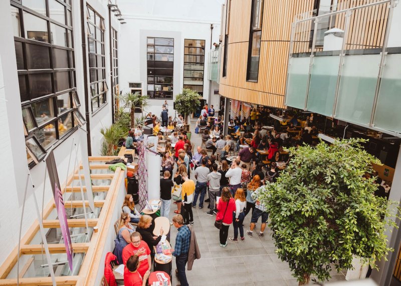 A crowd of parents and students at an Open Day inside Falmouth University's campus cafe