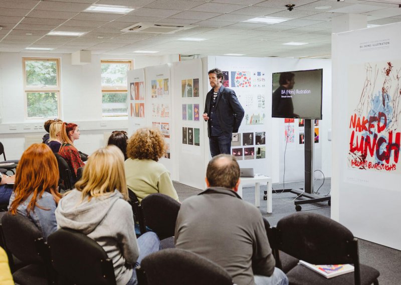 Falmouth University Illustration lecturer talking to group of prospective students and parents.