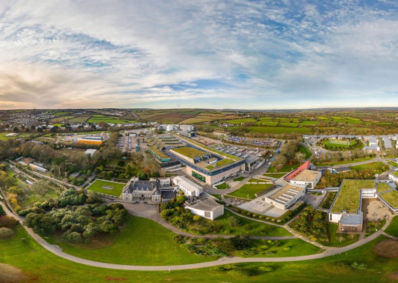 A wide angle aerial shot of Penryn campus with buildings and fields.