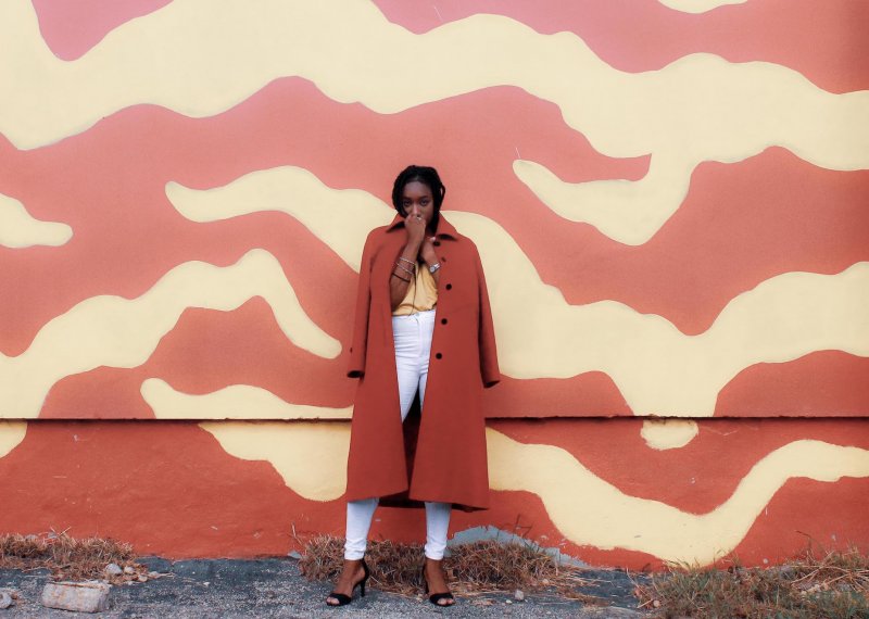 Student posing in a red coat for fashion marketing photo