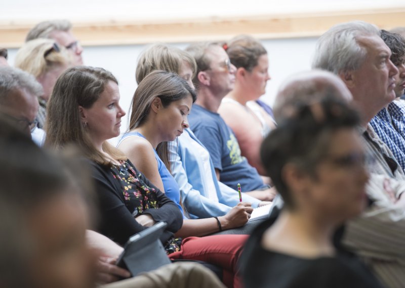 Men and women seated in a crowd