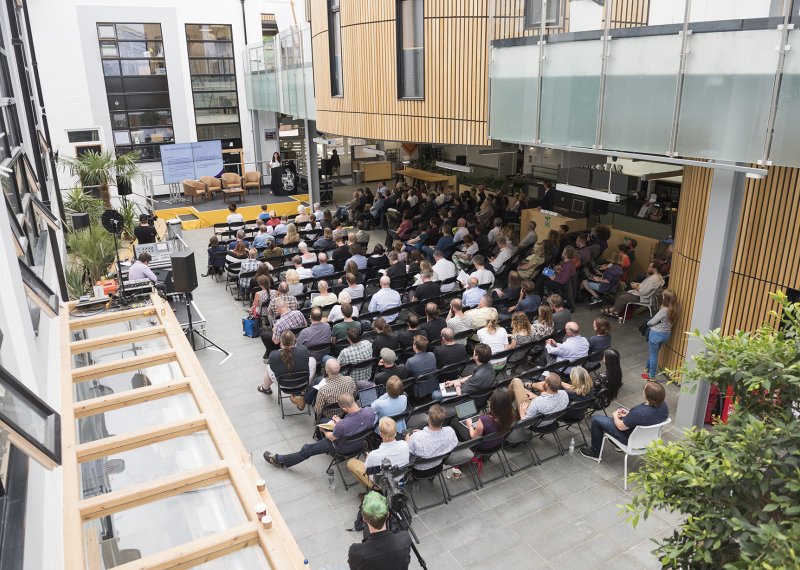 Delegates seated in front of a stage for an event in Fox Cafe 