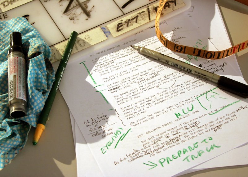 Printed script with annotations and pens