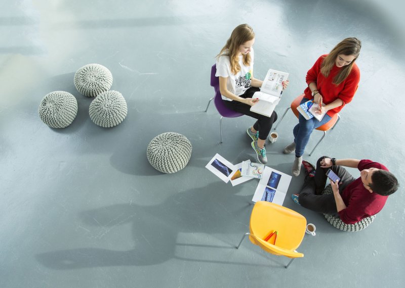 Falmouth University Business students sitting on chairs, having a discussion