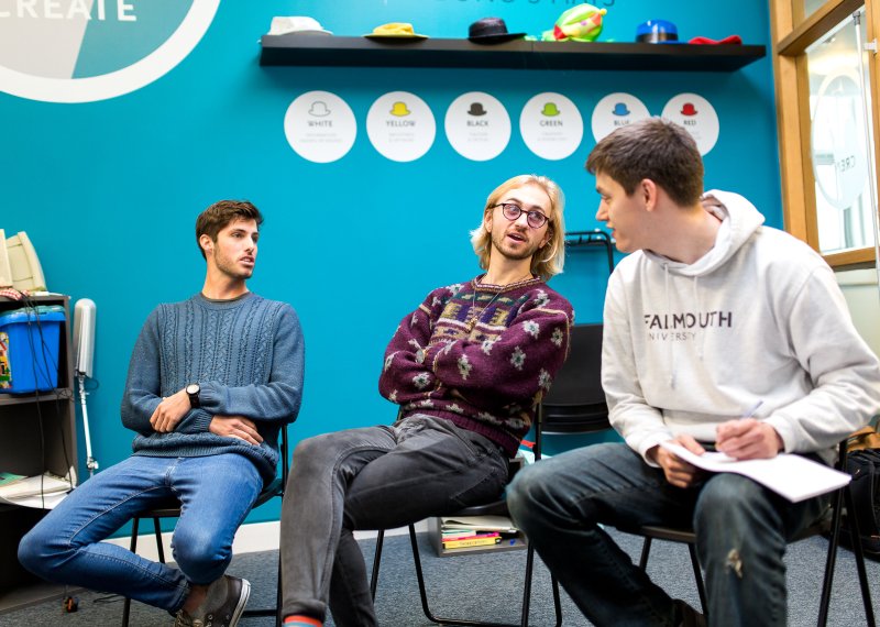 Students sat on chairs and having a discussion.