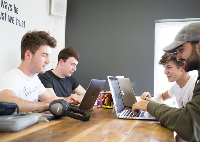 Students sat at laptops in Penryn campus cafe.