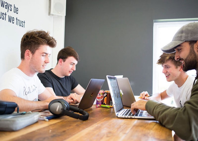 Business students working on laptops