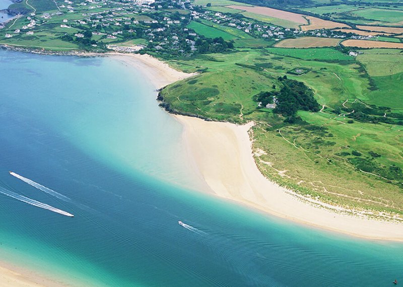 Aerial view of an estuary with sandy beaches and fields