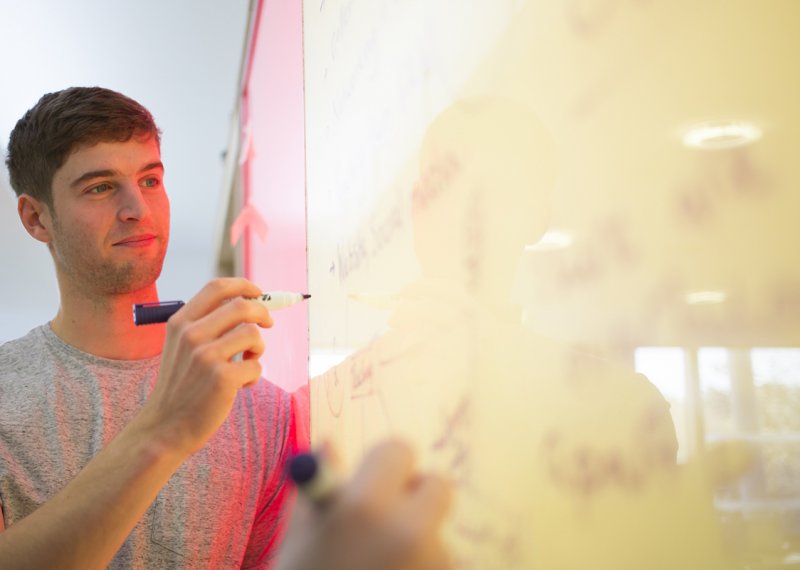 Falmouth student at a whiteboard