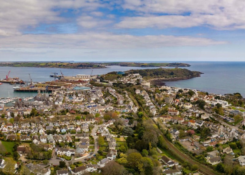 View from above of Falmouth, houses, coastline, sea and clouds.