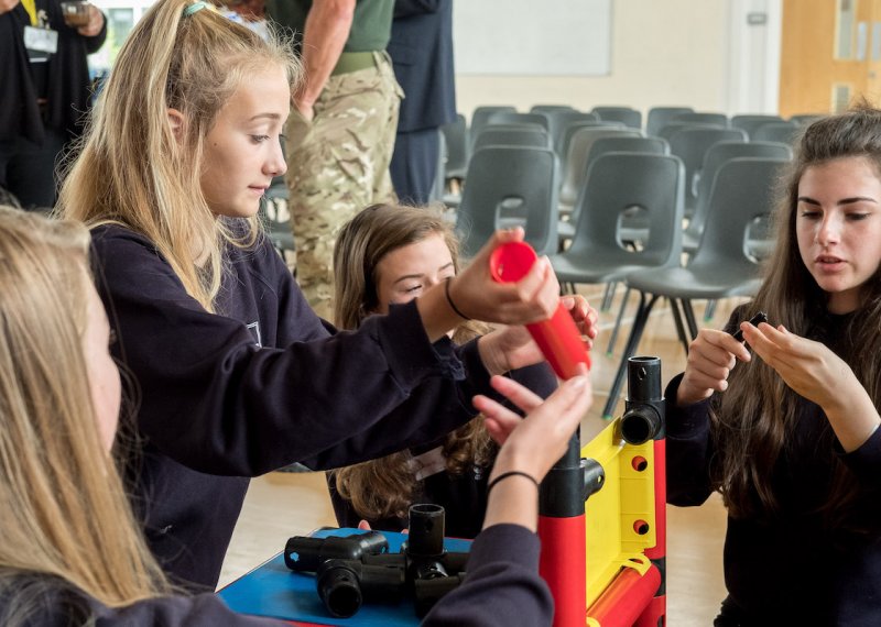 school girls building a plastic structure