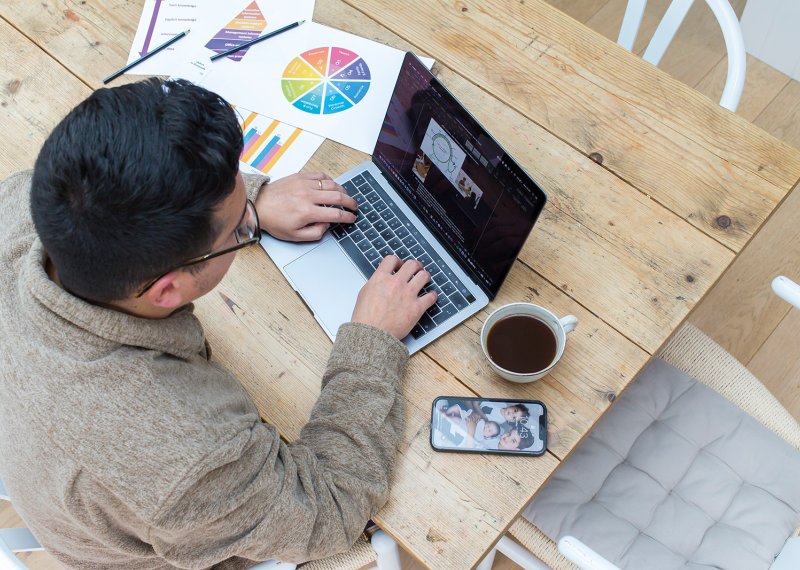 Person sat at a desk working on a laptop