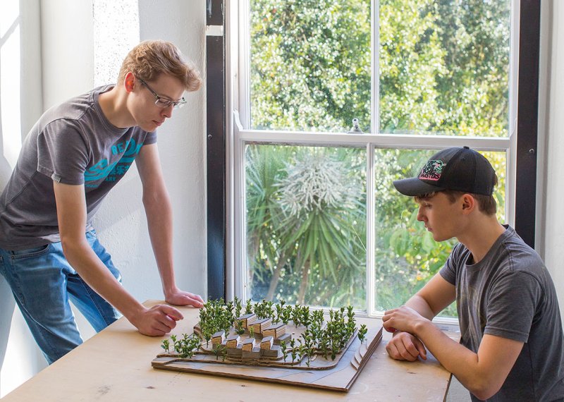 Architecture students looking at model buildings