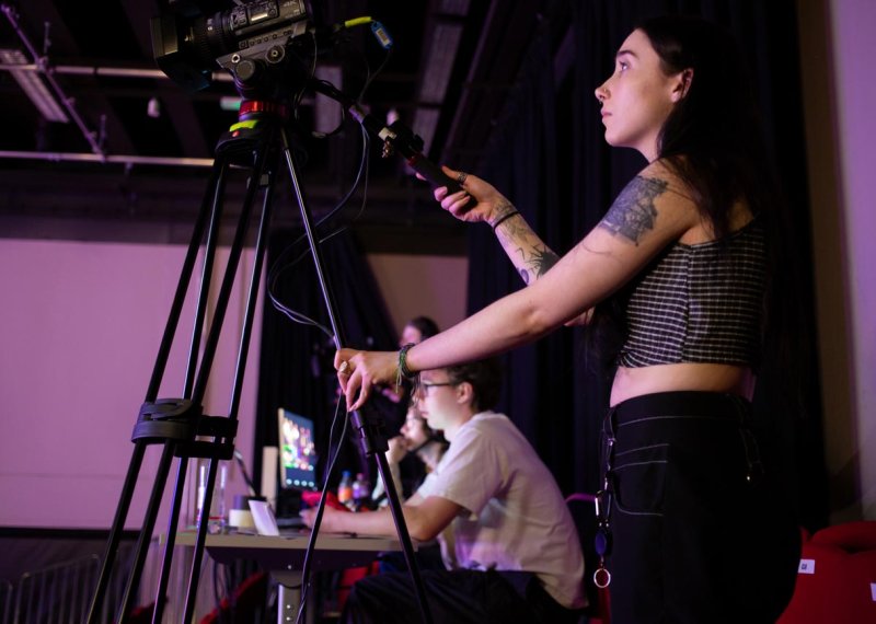 A Falmouth University student operating a camera at the 2025 Games Expo