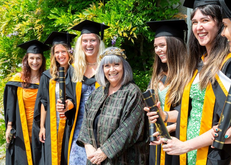 Chancellor Dawn French with female students at Falmouth University graduation ceremony
