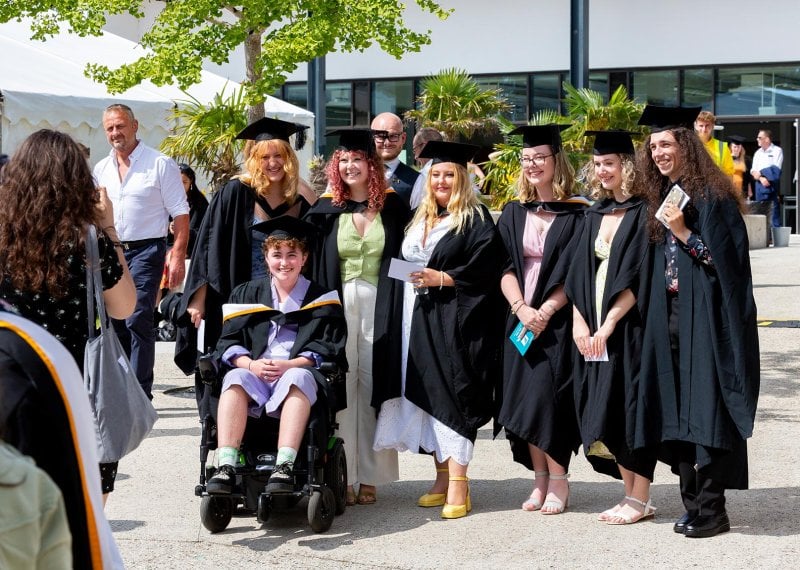 A group of students in gowns at Falmouth University's 2023 graduation