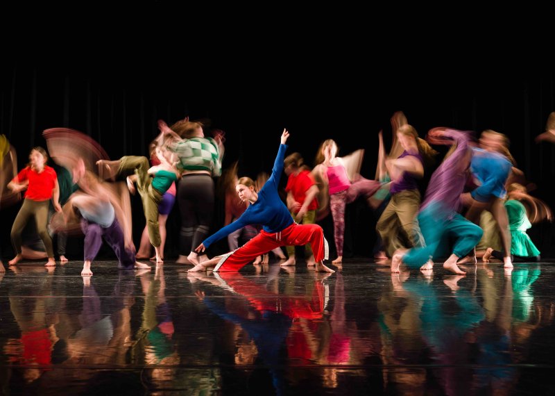 Group of dancers in brightly coloured clothes