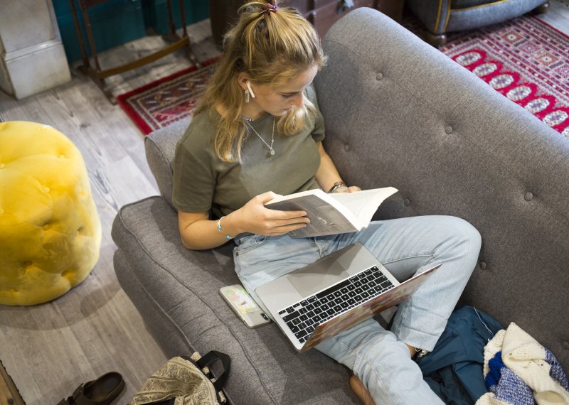 A student sat on a sofa 