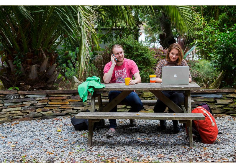 A man and a woman sitting on a bench