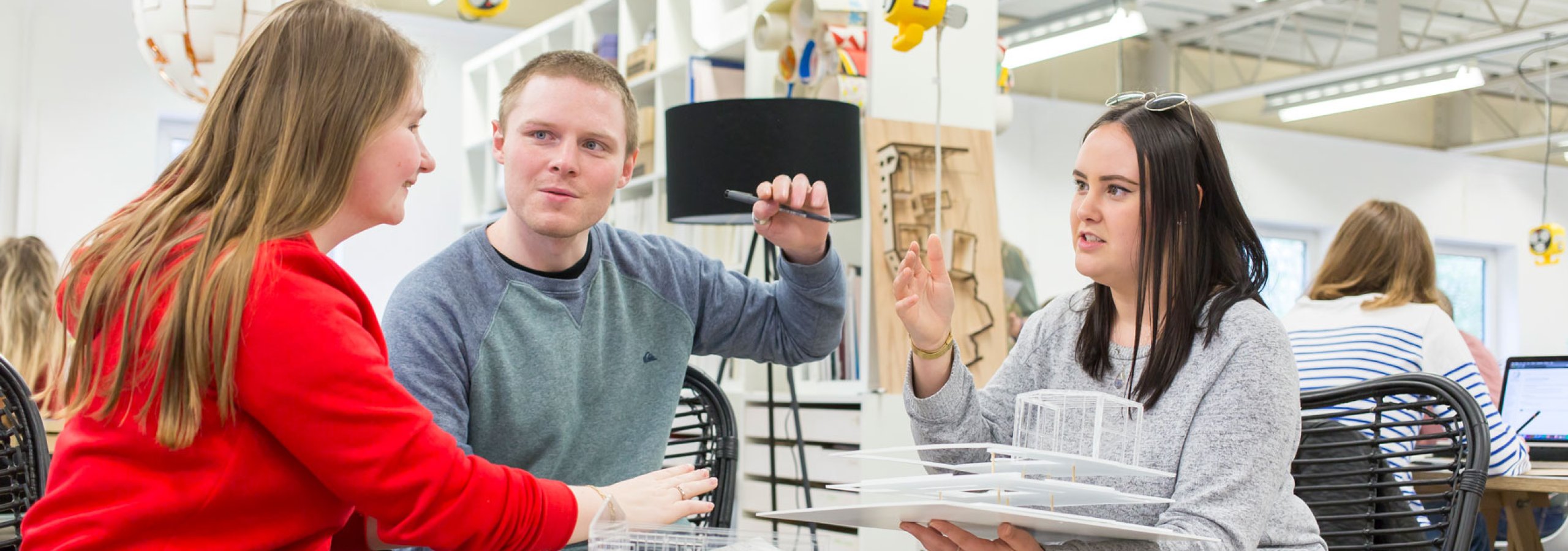 Three Falmouth University Interior Design students in the studio