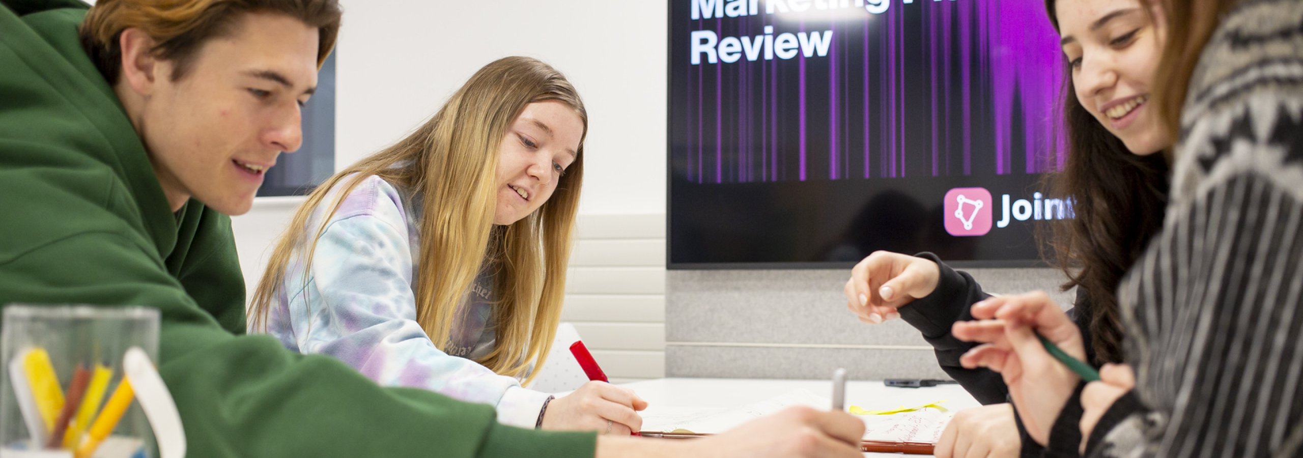Group of students sat round a table mind mapping