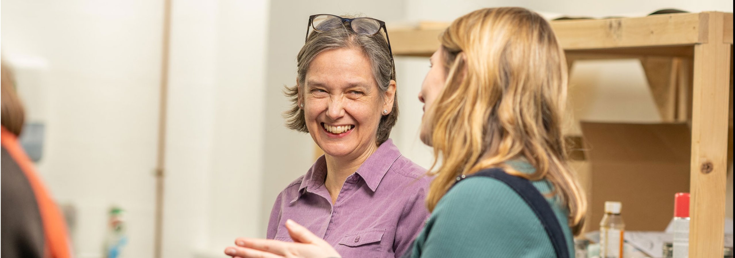 Two women at Falmouth University talking and smiling