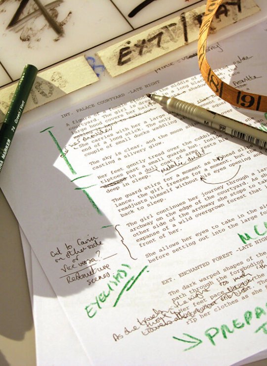A printed piece of paper with green ink annotations and pens