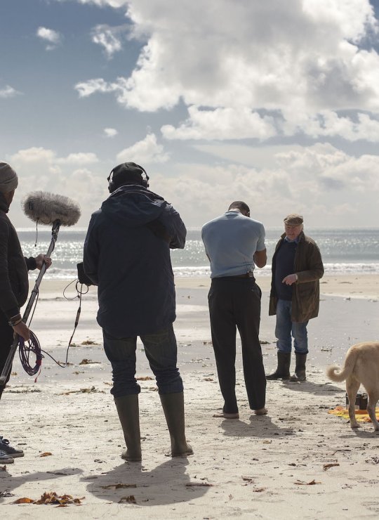Falmouth University student film crew on beach location.