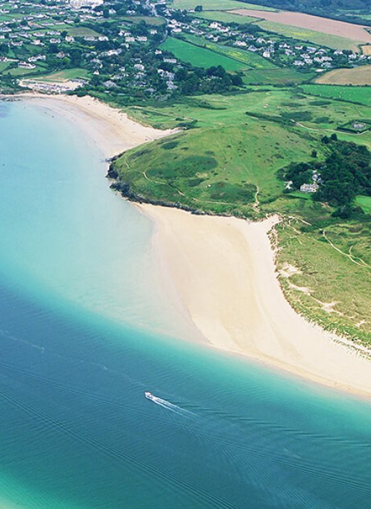 Aerial view of an estuary with sandy beaches and fields