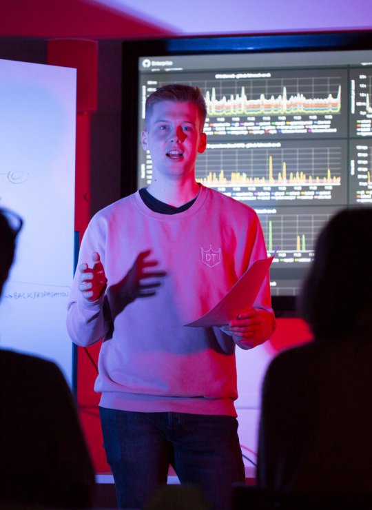 A student giving a presentation on coding