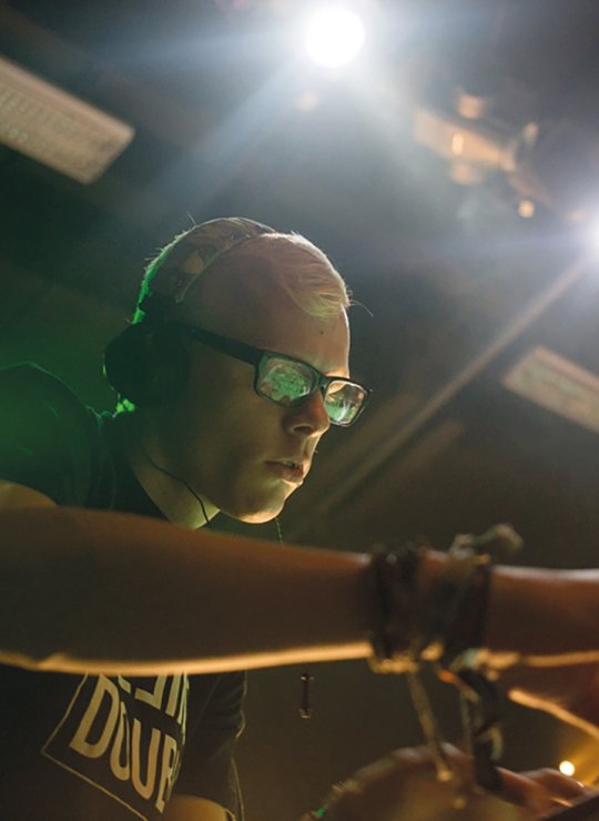 Person at a sound desk mixing music