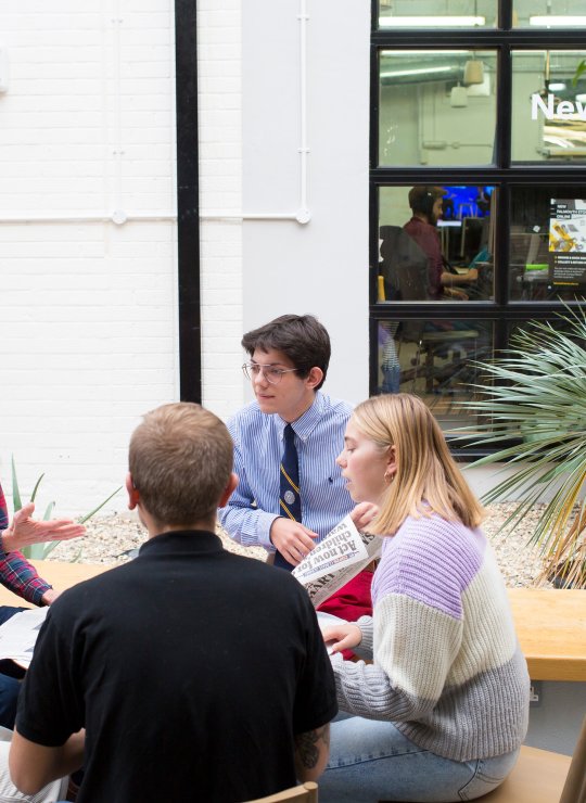 Journalism students sitting in a circle