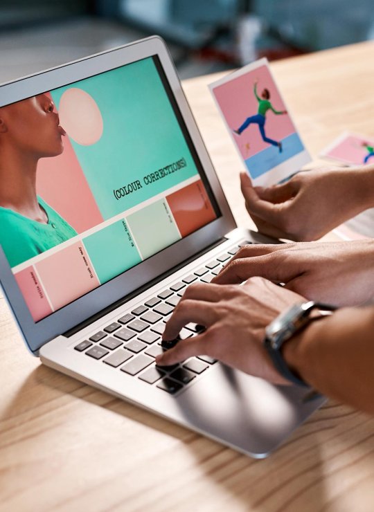 Hands working on a laptop