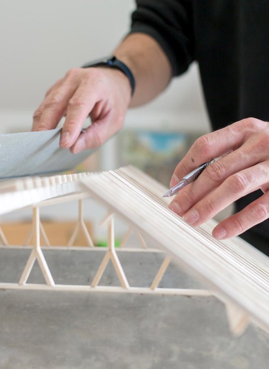 Hands holding an architectural model