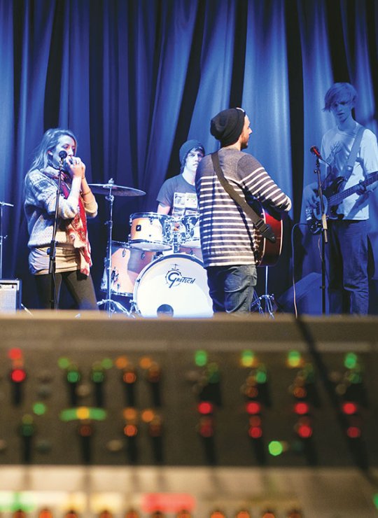 Band on a stage warming up with blue lighting