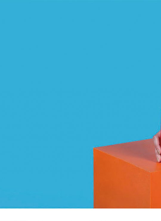 Brightly dressed female holding ketchup bottle