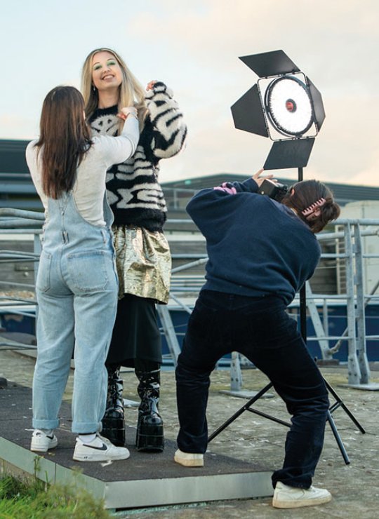 Students styling fashion shoot on rooftop