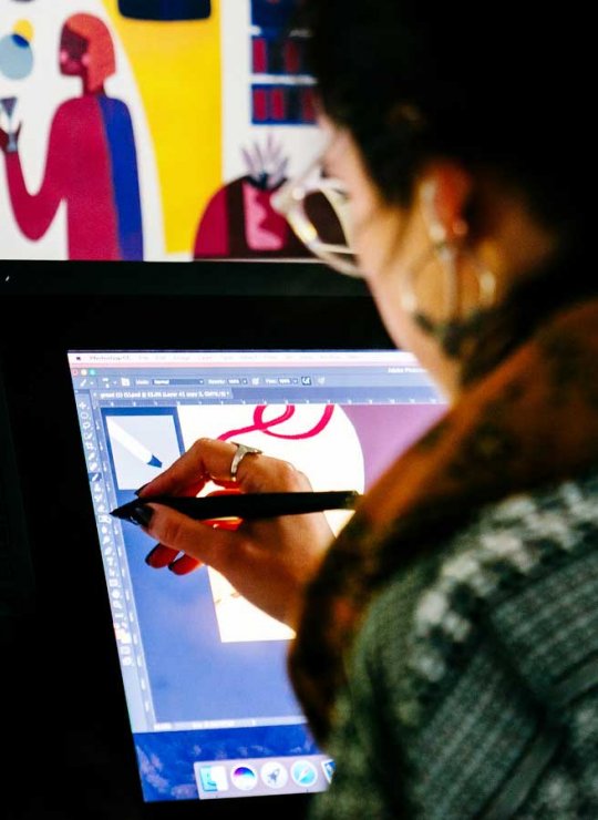 Visual Communication student drawing on a tablet