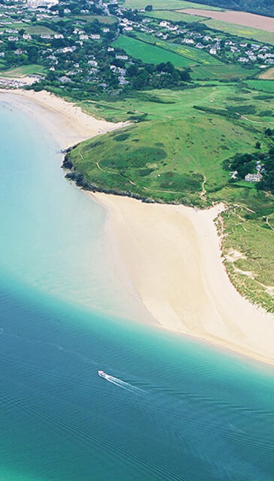 Aerial view of an estuary with sandy beaches and fields