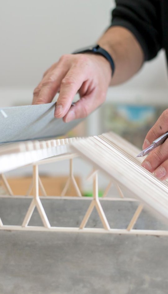 Hands holding an architectural model