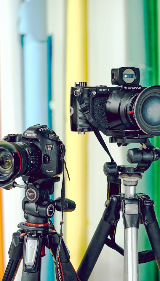 Set of 4 different types of cameras on tripods
