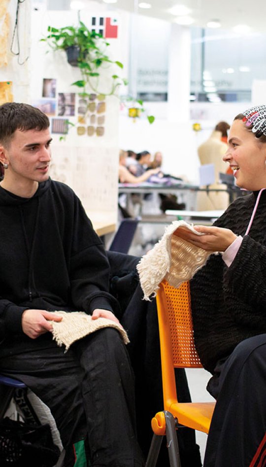 Students chatting in textiles studio